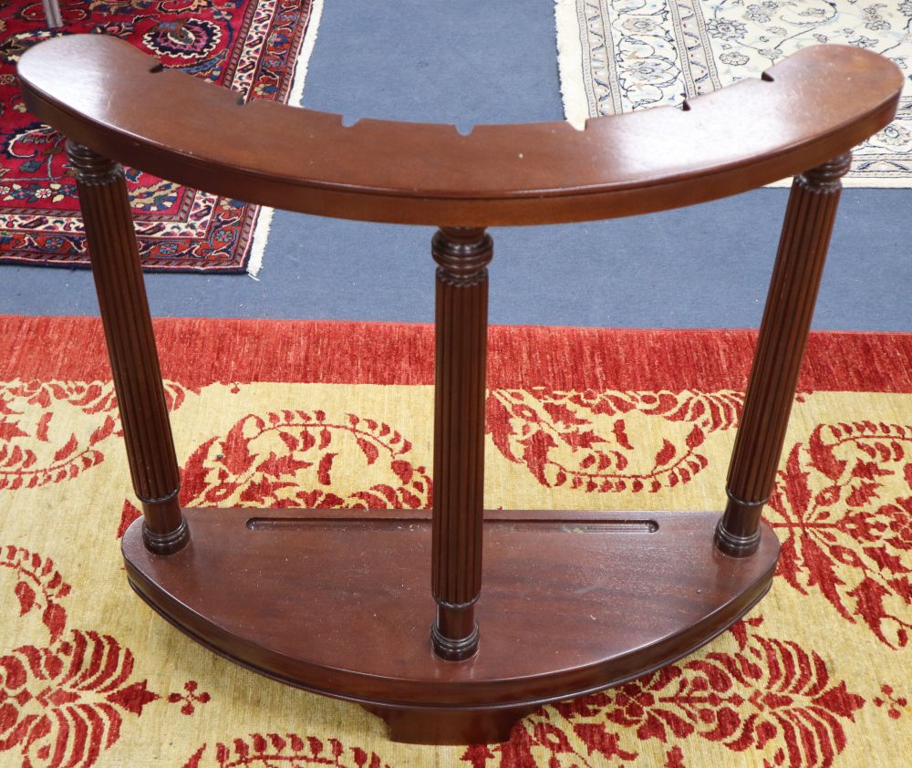 A mahogany sword stand, bow shape with reeded columns, claw feet, 92cm